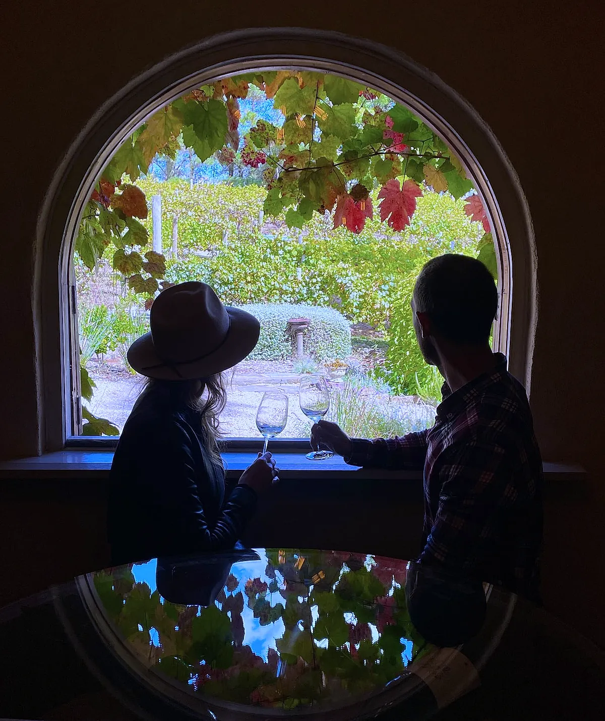 Two guests at the arched window with a glass of wine, late afternoon